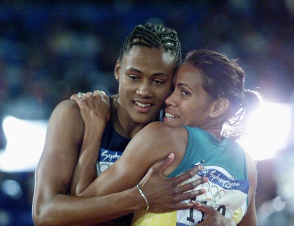 Women's 200m final winner Marion Jones USA, left, being congratulated by Cathy Freeman of Australia.