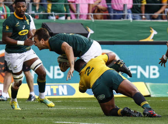 Australia's Folau Faingaa tackles South Africa's Andre Esterhuizen during their rugby test match in Port Elizabeth.
