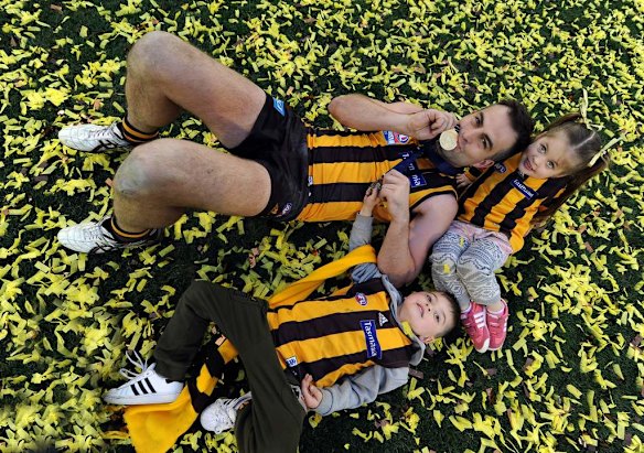Norm Smith winner Brian Lake celebrates with daughter Mylee and son Cohen.
