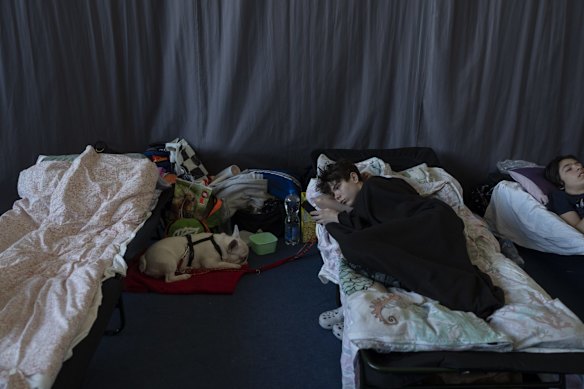 People who fled the war in Ukraine rest inside an indoor sports stadium of a high school in Przemysl, south-east Poland.