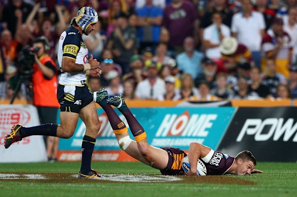 Corey Oates of the Broncos scores a try.