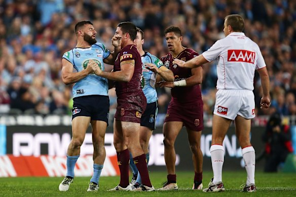 Josh Mansour of the Blues faces off with Matt Gillett of the Maroons.