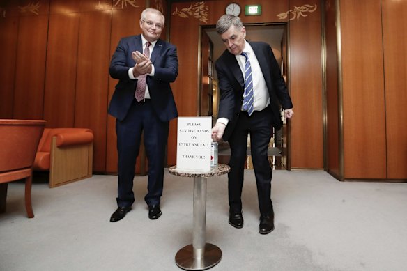 Prime Minister Scott Morrison and Chief Medical Officer Professor Brendan Murphy sanitise their hands before entering a National Cabinet meeting to discuss COVID-19 coronavirus, at Parliament House in Canberra.