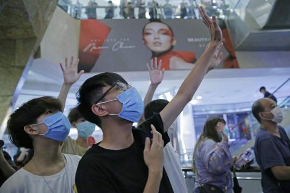 Protesters gesture with five fingers, signifying the "Five demands - not one less", during an anti-government protest in Hong Kong.