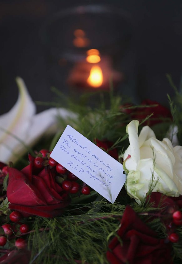A candle burns nex to flowers at the entrance to Schiphol Airport in memory of flight MH17 on July 18, 2014 in Amsterdam, Netherlands.  Malaysia Airlines flight MH17 travelling from Amsterdam to Kuala Lumpur crashed yesterday on the Ukraine/Russia border near the town of Shaktersk. The Boeing 777 was carrying 298 people including crew members, the majority of the passengers being Dutch nationals, believed to be at least 173, 44 Malaysians, 27 Australians, 12 Indonesians and 9 Britons. It has been speculated that the passenger aircraft was shot down by a surface to air missile by warring factions in the region.