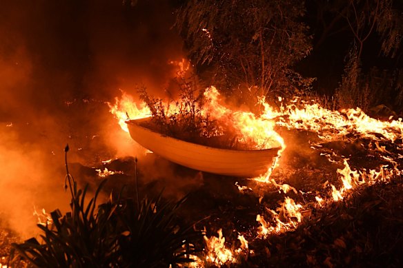 Surreal images at in Failford as a small rowboat burns after a fire swept the community.