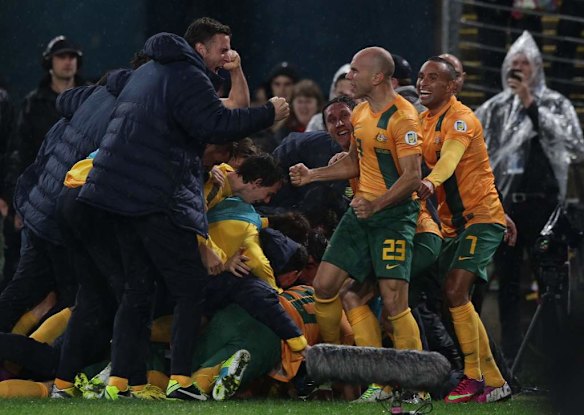 Socceroos celebrate Josh Kennedys goal.