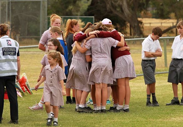 Friends huddle together as they visit the Tyabb oval.
