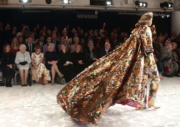 Britain's Queen Elizabeth, second left, sits next to fashion editor Anna Wintour, third left, and Caroline Rush, chief executive of the British Fashion Council (BFC) as they view Richard Quinn's runway show.