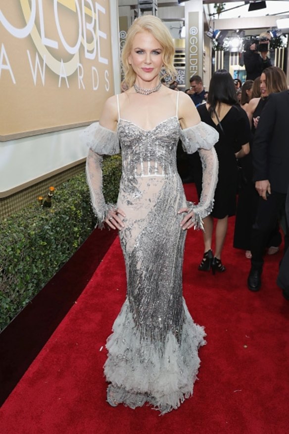 Nicole Kidman is taking a risk in  McQueen. The dress is a sheer grey mermaid gown with puffed gloves sleeves.