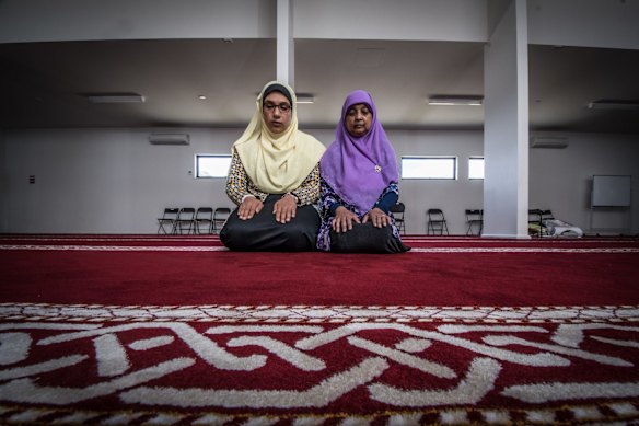 Mai Shouman and Mehekun Nisa pray at Gungahlin Mosque on Saturday afternoon.
