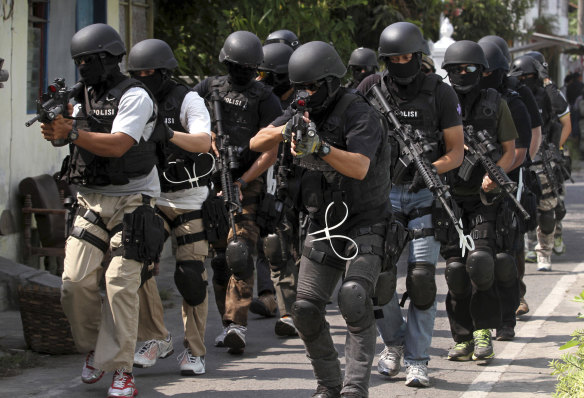 Officers from Indo<em></em>nesia police anti-terror unit Detachment 88 prepare for a raid.
