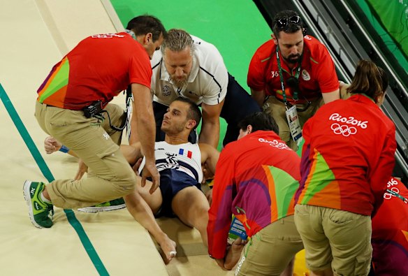 Samir Ait Said of France receives medical attention after breaking his leg while competing on the vault during the Artistic Gymnastics Men's Team qualification.