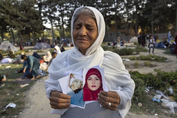 Zoohra, 60, holds the photo of her daughter, who she said was killed by the Taliban one month ago, at a makeshift IDP camp in Share-e-Naw park on August 12, 2021 in Kabul, Afghanistan. 