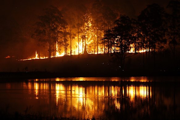 Hillville fire reflects on water during NSW bushfire emergency. 