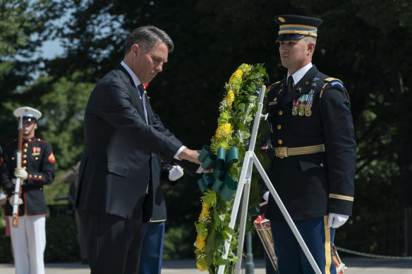 Australian Deputy Prime Minister Richard Marles, left, lays a wreath at Arlington National Cemetery during his first visit to the US since taking office.