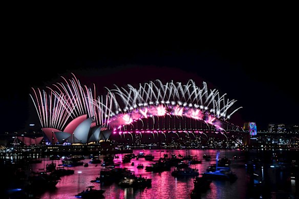 The New Years Eve Midnight fireworks light up the Sydney Harbour Bridge and Opera House.