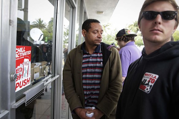 UC Santa Barbara student Derrick Hayes, center, sheds tears in front of  IV Deli Mark where Friday night's mass shooting took place by a drive-by shooter.