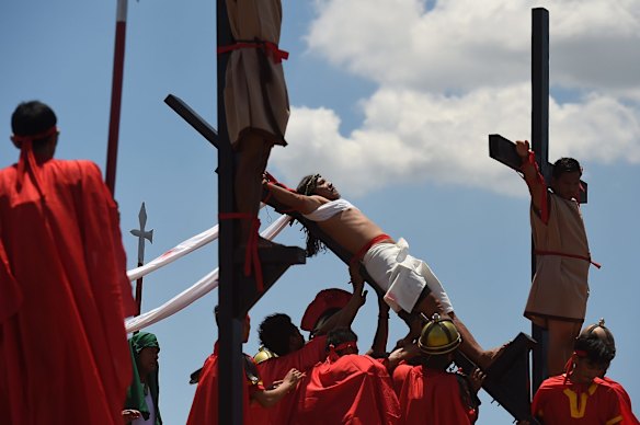 Reuben Enaje re-enacts Christ's crucifixion in Barangay San Pedro Cutud in Pampanga, north of Manila