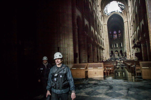 A man walks inside the damaged Notre Dame cathedral on Tuesday.