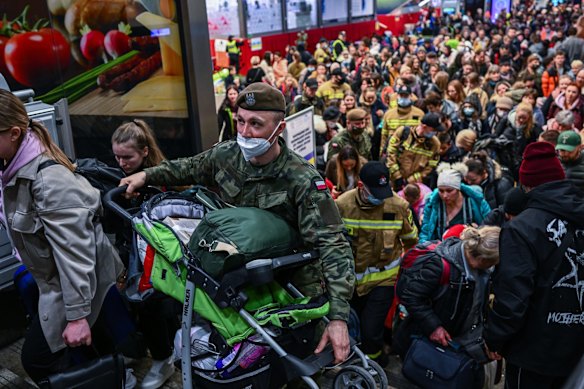 People who fled the war in Ukraine walk towards a humanitarian train to relocate refugees to Berlin in Krakow, Poland. More than half of the roughly 3 million Ukrainians fleeing war have crossed into neighbouring Poland since Russia began a large-scale armed invasion of Ukraine.