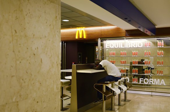 A refugee sleeps at McDonalds early in the morning at Milan Central Train Station. Some refugees have been taken to reception centres, some sleep in the parks and streets surrounding the station but others will avoid the reception centres and move onto a another country as soon as possible. 