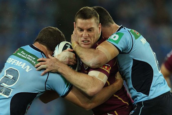 Maroons Chris McQueen held up by Blues Ryan Hoffman.