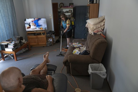 Booraja Home Care worker Narelle Welsh, vacuuming  Norman Russell's home in Broulee.