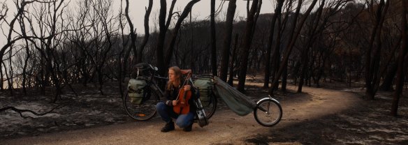 Kristin Rule on her bike with viola in Mallacoota. 