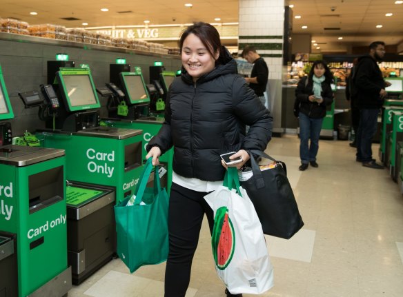 A model carries her Bag for Good and spliced fruit Woolworths bags on the runway at their resort show.