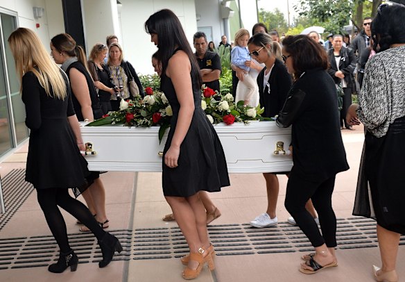 Friends and family carry Tara Brown's coffin into her funeral service.