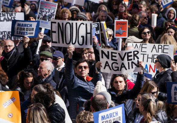 Students carried placards "Enough" to call for a stop to gun violence. 