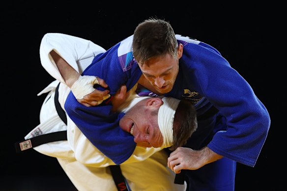 Nathan Katz (white) of Team Australia competes against Gregg Varey (blue) of Team Wales during the Men's Judpo 66 kg Repechage match.