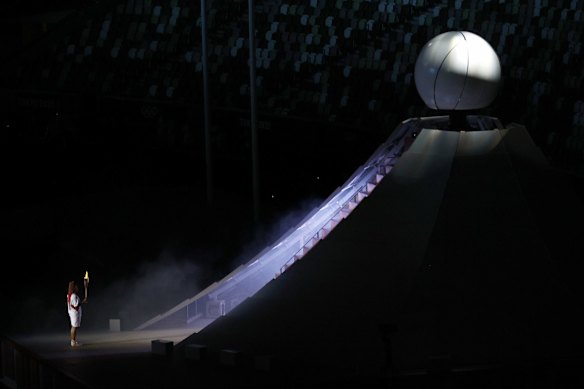 Naomi Osaka of Team Japan lights the Olympic cauldron.