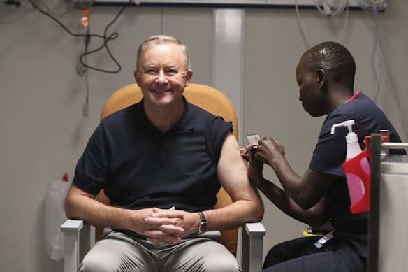 Opposition Leader Anthony Albanese receives his COVID-19 vaccination from registered nurse Yom Mapiou at the Canberra Hospital surge centre.