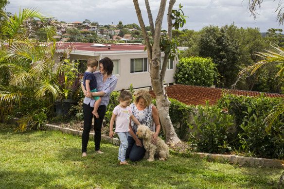 Rachel Barry, with her children Lily and Jimmy, and neighbour Lou Shanahan are concerned that a proposed apartment building breaches planning rules.