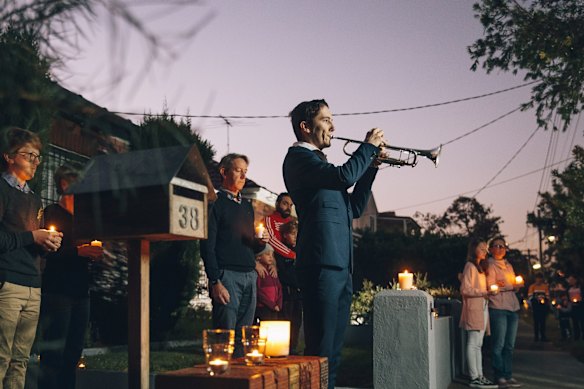 Albie Woodhouse plays The Last Post on trumpet for a driveway dawn service for ANZAC Day in Daceyville.