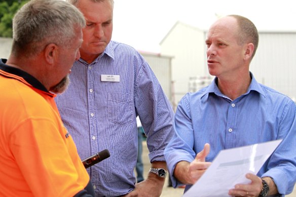 Lachlan Miller and Premier Campbell Newman speaking with Peter Haylock an employee at the Emerald Carrying Company in Emerald. 