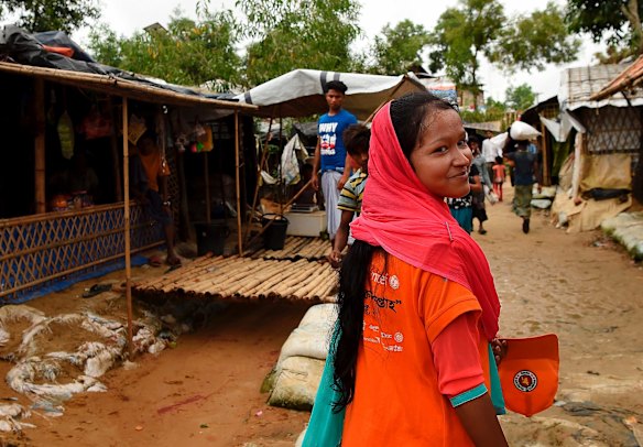 Amina Akhter who works as an outreach officer for the UNICEF nutrition centre in Balukhali Camp walks towards one of her clients who she is about to visit.