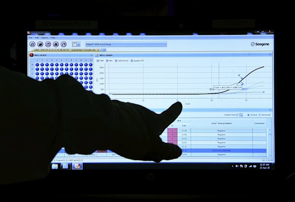 Senior Hospital Scientist Anna Condylios pointing out a positive coronavirus curve. 