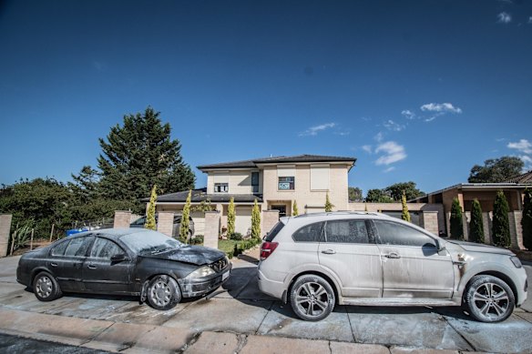 Police officers and forensic staff attend the scene of an overnight shooting and arson attack in Harrington circuit, Kambah. Numerous bullets have hit the home and three vehicles have been set alight. 