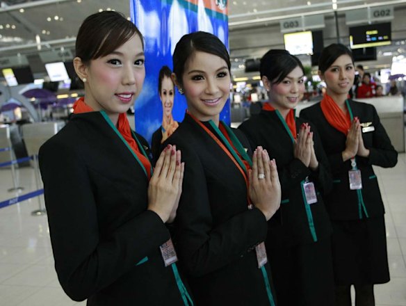 Thai transsexuals flight attendants, from left to right, Chayathisa Nakmai, Dissanai Chitpraphachin, Nathatai Sukkaset and Phuntakarn Sringern pose for photograph at a check-in counter for PC Air at Suvarnabhumi international in Bangkok.