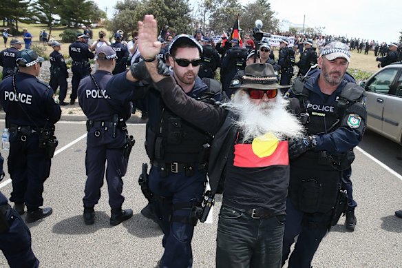 A man from anti-racism rally is arrested during the march along the beach in Cronulla.