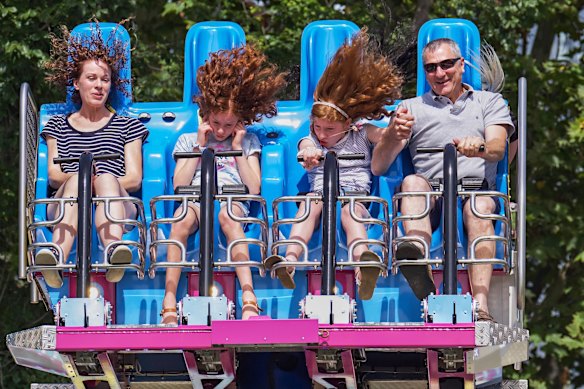 Lucy with partner Branko enjoying one of the rides with daughters , Amy, 11 and Laura, 9 at Moomba.
