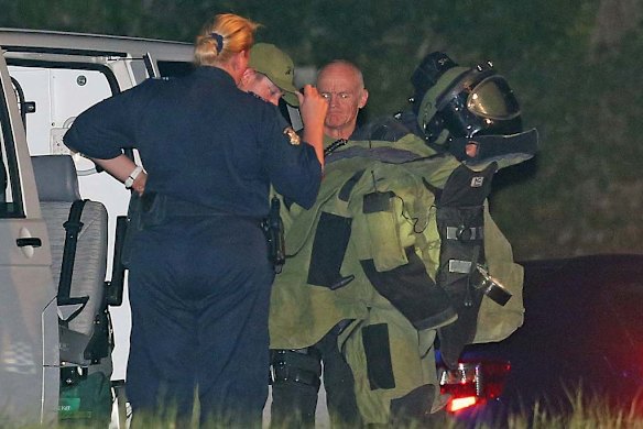 A bomb squad officer gets suited up at the scene.