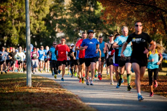 Parkrunners get cracking in Tuggeranong, one of the Canberra events called off due to excessive smoke. 