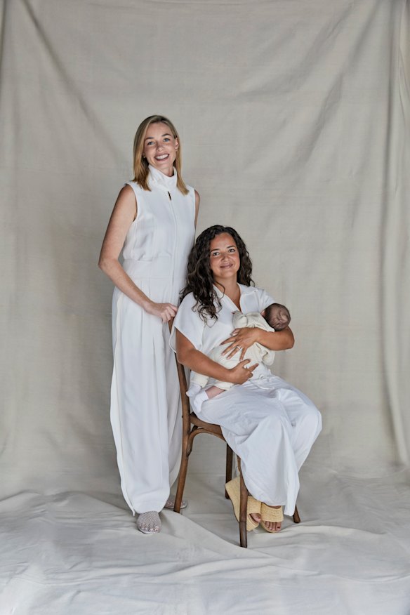 Ashleigh Raper (standing) carried baby Mia as a surrogate for her best friend, Lucy Koops.
