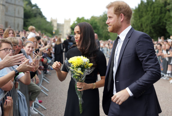 Meghan Duchess of Sussex and Prince Harry, Duke of Sussex speak with well-wishers at Windsor Castle.