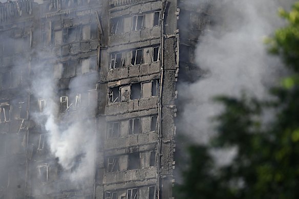 Smoke rises from the building after a huge fire engulfed the 27 story Grenfell Tower in Latimer Road, West London in the early hours of this morning on June 14, 2017 in London, England. The Mayor of London, Sadiq Khan, has declared the fire a major incident as more than 200 firefighters are still tackling the blaze while at least 30 people are receiving hospital treatment. 