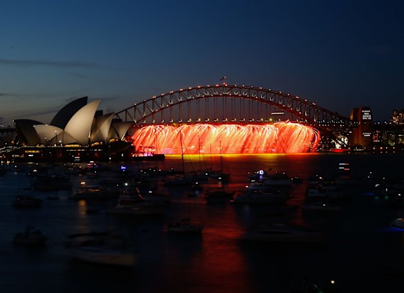 The Sydney Harbour Bridge is lit up prior to the 9pm New Year's Eve fireworks on Sydney Harbour, as viewed from Mrs Macquarie's Chair.